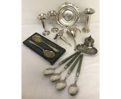 A box of mixed silver plated items.  To include decorative inkwell, a wine funnel and serving spoons. 