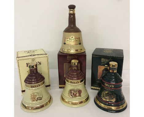 A collection of 4 Wade ceramic Bells whisky bell shaped decanters (empty).  Comprising 3 boxed 1990's Christmas decanters and