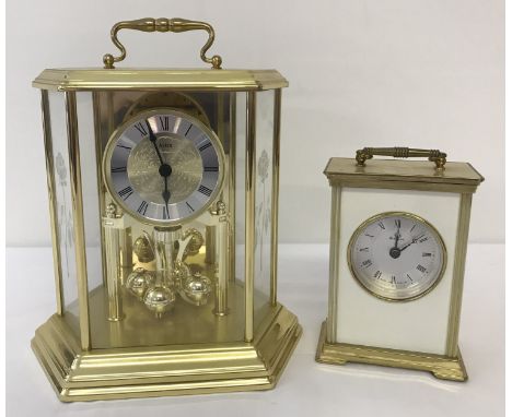 2 vintage carriage clocks.  An acctim Germany glass panelled torsion ball pendulum clock, together with a metamec quartz cloc