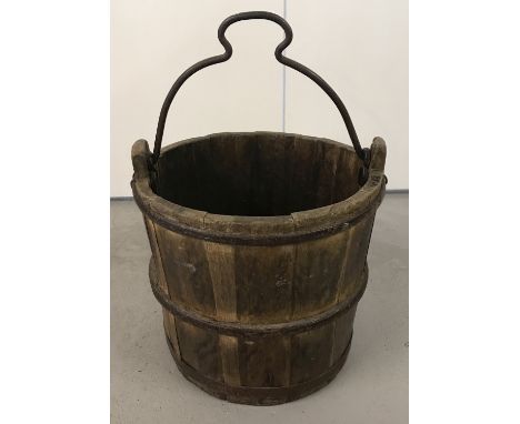 A vintage heavy wooden well bucket with metal banding.   Approx. 33cm tall x 33cm diameter.