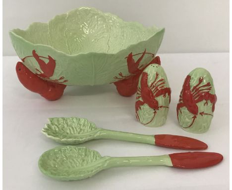 A vintage Carlton Ware ceramic lobster salad bowl with matching salad servers and cruet.  Bowl is raised on 3 lobster shaped 