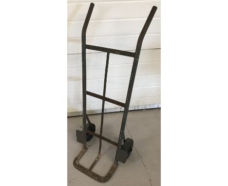 A vintage metal sack barrow with hard rubber wheels.   Approx. 103cm tall.