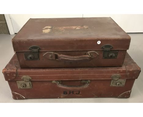 A pair of vintage leather suitcases with travel labels. Largest showing previous owner's initials. Large W70cmxD43xH24