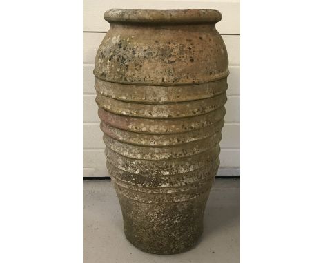 A large vintage terracotta garden urn with ribbed decoration to body.  Approx. 74cm tall x 40cm dia.