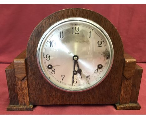 An Art Deco oak cased mantel clock with Westminster chime, in working order.  Garrard movement, complete with key and pendulu