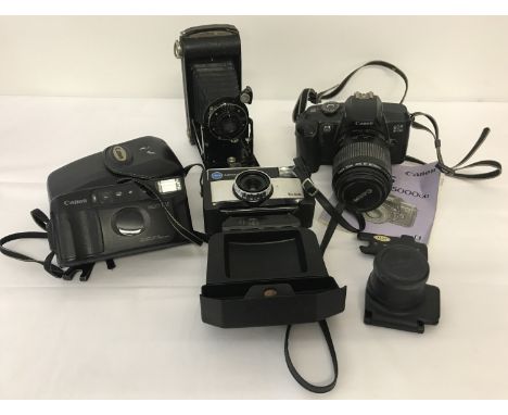 A Canon EOS 5000 camera with Canon EF 80-200mm zoom lens. With instructions.  Together with a vintage Kodak Junior folding ca