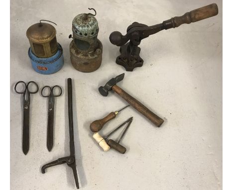 A collection of assorted vintage tools.  To include a wooden handled leather press, cobblers hammer, scissors and car heaters