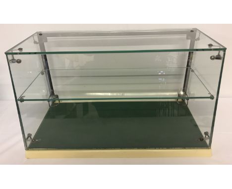 A vintage open backed countertop glass display cabinet.  With single interior shelf. Approx 34 cm tall x 60 cm long x 32 cm d