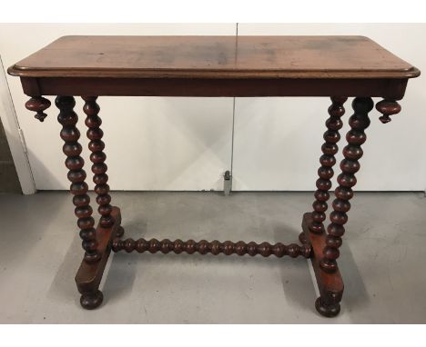 A Victorian mahogany hall table raised on bobbin legs and bun feet.  With bobbin shaped central support and turned finial dec