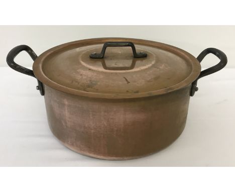 A vintage heavy copper, 2 handled, lidded cooking pot.   Approx. 25.5cm diameter.