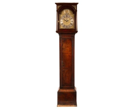 An 18th Century walnut longcase clock, circa 1720, the hood with brass spandrels and plain columns, the brass arch dial with 