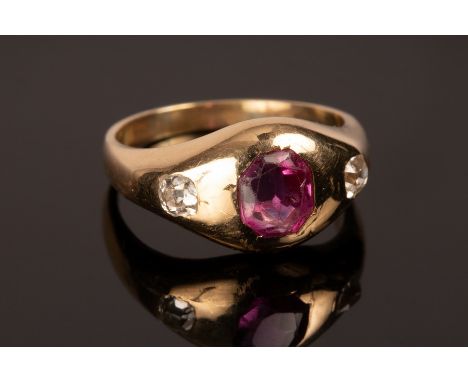 A ruby and diamond three-stone ring in an unmarked yellow metal gypsy setting, size L, approximately 5.3g/see illustration CO