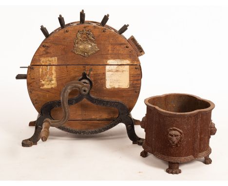 A Kent patent knife grinder, 63cm high and a cast iron jardinière, 28cm high CONDITION REPORT: Condition information is not u