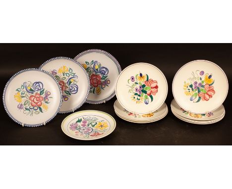 Poole Pottery, three floral decorated plates, 23cm diameter, nine smaller floral plates, 21cm diameter and a shallow dish CON