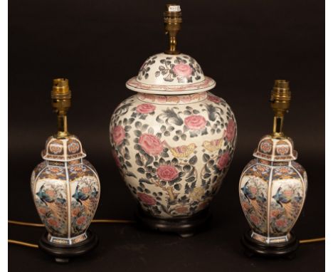 A vase and cover decorated rose trees and birds, 66cm high (now a lamp with shade) and two others, both with shades CONDITION
