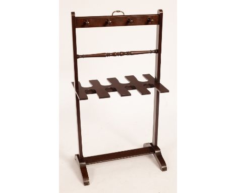 A 20th Century country house mahogany boot and whip rack with eight pegs and brass handle, on splayed supports, 74cm high, 50