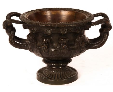 A late 19th Century bronze model of the Warwick vase, twin wrythen handles and Bacchic ornament, 13cm x 21cm (including handl