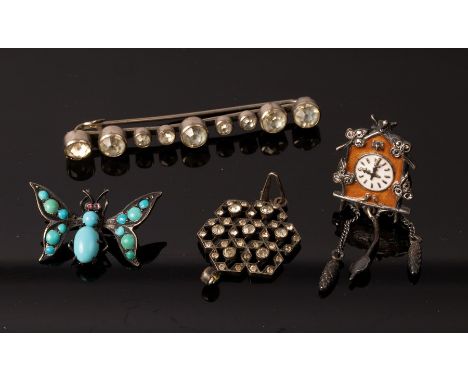 A novelty scarf clip of butterfly form, set in turquoise and with gem set eyes, 3cm wide, a novelty brooch of cuckoo clock fo