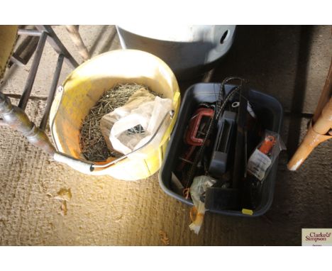 A builders bucket with large quantity of nails; and a tool tray with various hand tools