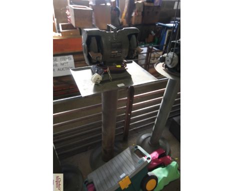 A Speedy bench grinder mounted on pedestal
