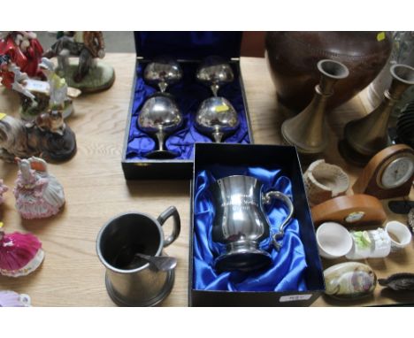 A box set of four silver plated goblets; an engraved tankard; pewter tankard and spoon