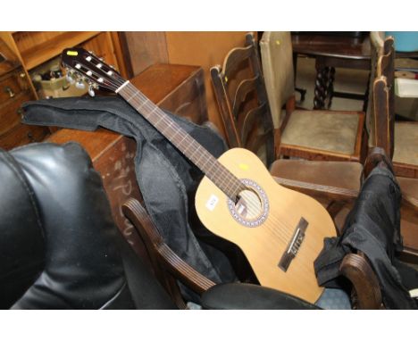 An acoustic guitar and carrying bag