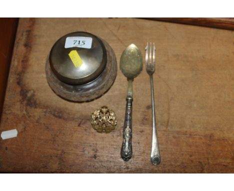A cut glass and silver topped jar; silver handled spoon; silver plated pickle fork and an RAF badge