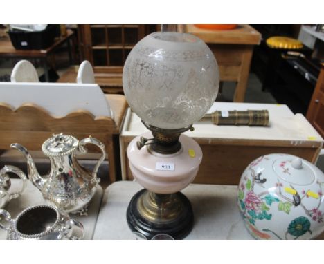 A brass based oil lamp with opaque glass font