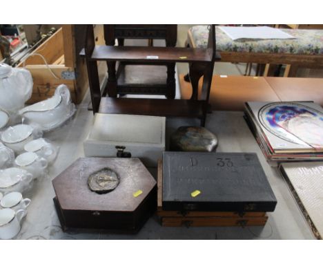 An open wall shelf; a jewellery box; a tin of buttons; a trinket box and three empty slid boxes