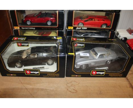 Two Burago die cast models: a Mercedes Benz 300SL and a Ferrari Testarossa