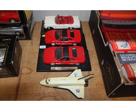 A model of an American space shuttle and three die cast models: Mercedes Benz 280SE and two Ferrari 458s