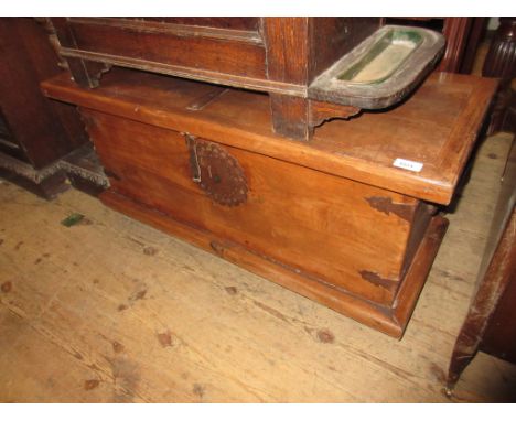 Indian hardwood iron bound trunk having hinged cover on low bun supports, 19.5ins high x 39ins wide and 15ins deep 