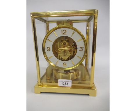 Jaeger LeCoultre ' Atmos ' clock, the gilt brass four glass case enclosing a white enamel dial with Arabic and baton numerals