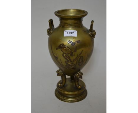 Late 19th Century Japanese gilt bronze two handled amphora shaped vase on tripod and circular plinth base, relief decorated w