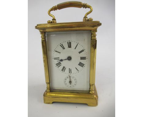 19th Century gilt brass two train carriage clock, striking on a bell, having a enamel dial with Roman numerals and subsidiary