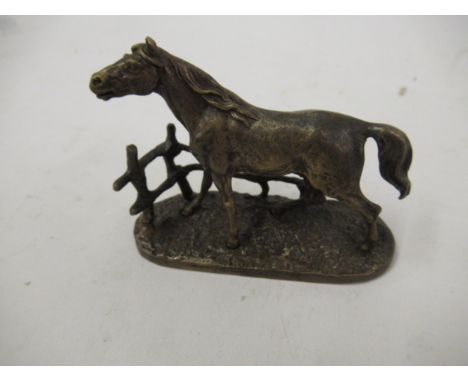 Miniature bronze figure of a horse on a naturalistic base, signed P.J. Mene, 3.25ins long 