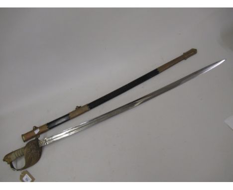 Late 19th / Early 20th Century Naval officers dress sword, having single fullered etched blade with gilt brass basket and sha