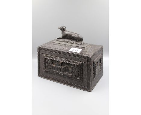 19th Century Irish bog oak tea caddy, the hinged cover surmounted by a figure of a dog, 9ins wide x 5.5ins deep x 7ins highSo