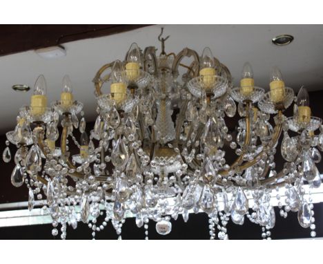 Mid 20th Century glass and gilt brass eighteen light electrolier, the hobnail baluster centre stem surrounded by scroll shape