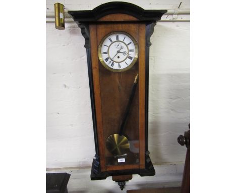 Vienna walnut and ebonised wall clock, the white enamel dial with Roman numerals and subsidiary seconds, with a single train 