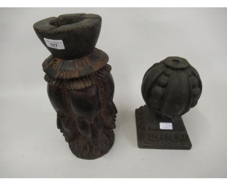 African carved hardwood candle stand, decorated with mask heads and a carved oak finial 