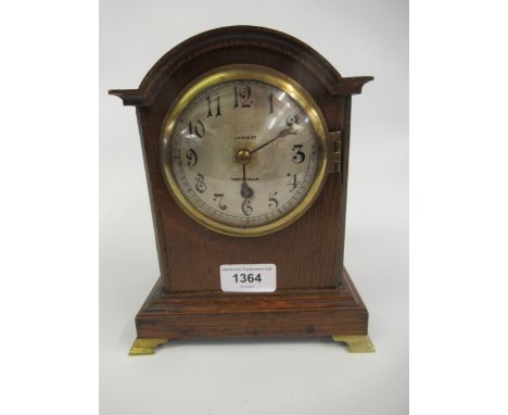 Small early 20th Century oak dome topped mantel clock, the silvered dial with Arabic numerals, inscribed Jack & Company, with