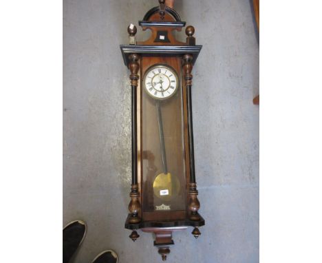 19th Century walnut and ebonised Vienna wall clock, the enamel dial with Roman numerals and subsidiary seconds, with a single
