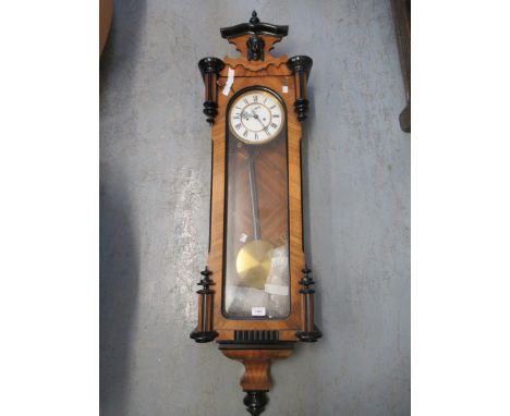 19th Century walnut and ebonised Vienna wall clock, the shaped surmount above a glazed door, the circular enamel dial with Ro