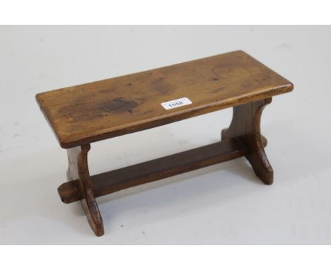 Unusual miniature yew wood model of a trestle ended table with stretcher, 6.5ins high x 13ins long x 6ins deep 