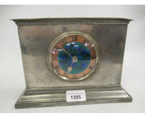 Liberty & Co. Tudric pewter mantel clock, the rectangular beaten case with a circular enamel and copper dial with Roman numer