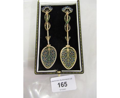 Cased pair of Continental silver gilt and enamel coffee spoons of floral designGood condition, not original case 