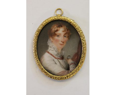 Early 19th Century oval miniature of a lady with white ruff collared blouse and coral necklace in a gilt metal mount, 3ins x 
