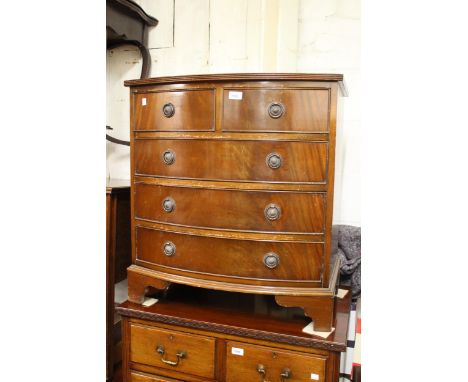 Small reproduction mahogany bow front chest of two short and three long drawers with ring handles and bracket feet, 27.5ins w