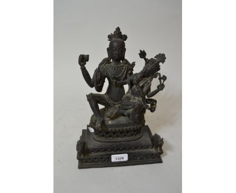 19th Century Indian dark patinated bronze group of Buddha and Ganesh, the rectangular stepped base mounted with animal figure